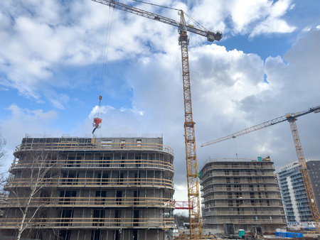 Tower cranes with new house on the construction site. Industrial conceptの写真素材