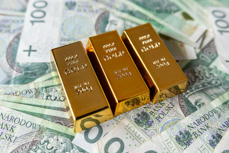 Gold bars on zloty money financial background. Wealth conceptの写真素材