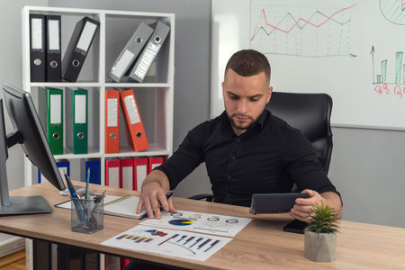 Business man work with charts and graphs with computer at modern office. Analyzing income documentの写真素材