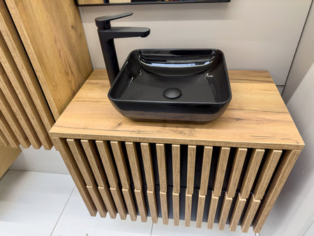 new modern black ceramic sink on wooden cabinet in the bathroom interiorの写真素材