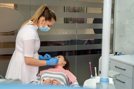 Caucasian woman is having her teeth consult and examined in dental clinic, healthcare concept. Medical Procedureの写真素材