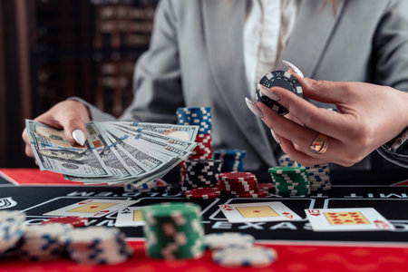 Female player count dollar cash as big win in poker game at casino. Gambling concept