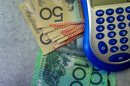 calculator with aus 50 100 australian banknotes  saving money concept