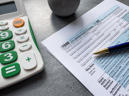 Tax accounting blank form pen and calculator on wooden table. Tax seasonの写真素材