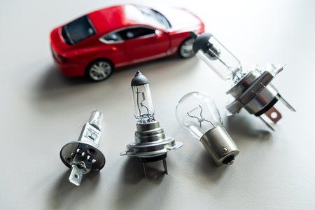 different automotive bulbs h1 h4 h7 a small toy car. Car repair conecptの写真素材
