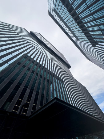 Perspective angle view to modern glass building skyscrapers. Glass facade in modern office building
