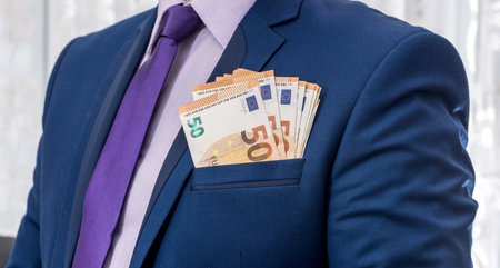 businessman in suit hold EU euro paper money. Wealth saving concept