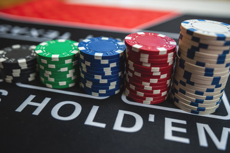 poker chips stack on a black casino table. Poker game theme, gambling concept. Win and luckの写真素材