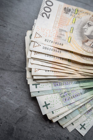pile of PLN 100 and 200 zloty bills finance background. Saving concept, currency of Poland