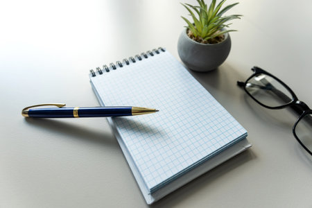 blank notebook with pen, eyesglass on office white workplace.  Space for your text. Business and education concept.の写真素材
