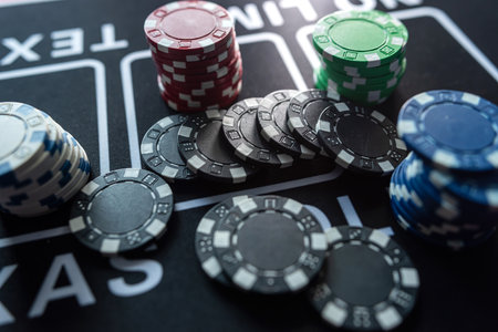 poker chips on black casino cloth table, gambling concept