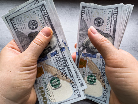 woman count 100 dollar bill or cash with money laundering. Fraud, accounting and investment conceptの写真素材
