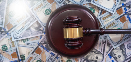 Wooden judge gavel with us usd dollars paper money. Auction bidding concept