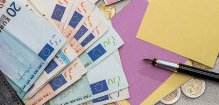 empty copybook memo with pen on euro bills. Money for dream. Future investment concept