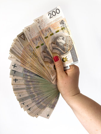 female hand holding zl polish zloty PLN banknotes paper currency isolated on white. Finance conceptの写真素材