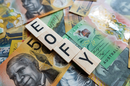 EOFY on a wooden cubes with Australia, 50 and 100 dollar banknotes. financial concept, end of a financial yearの写真素材