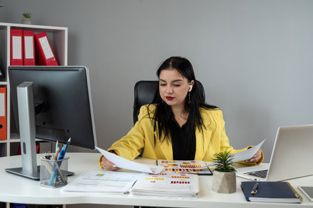 Business woman doing math finance or tax, annual report with financial documents and laptop at office. Accounting statistics conceptの写真素材