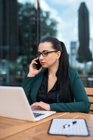 woman manager or female freelancer working laptop sitting on the cafe outside. Business conceptの写真素材