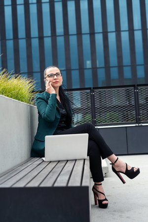 caucasian female freelancer or woman boss work online with laptop, outside the officeの写真素材