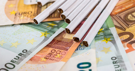 Euros paper Money EU with cigarettes. Concept of high prices of tabacoo. Unhealth lifestyleの写真素材
