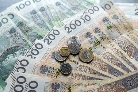 Polish 100 200 zloty banknote and coins grosz as background. Currency of Poland, finance concept