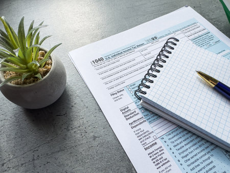 1040 individual income tax form pen empty sheet notepad on desk. The time to pay taxesの写真素材