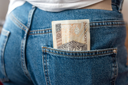100 200 Lots of Polish banknotes of the back pocket of denim pants. Money in a Jeans Pocketの写真素材