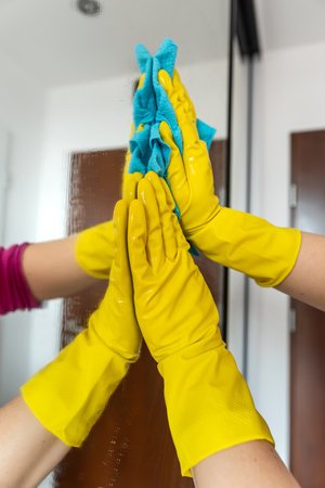 hand wipes the glass in the cabinet with a rag. General cleaning of the apartmentの写真素材