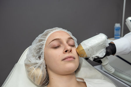 cosmetologist making laser epilation on the woman face while visiting beauty center on salon. Health...