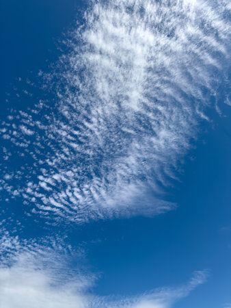 few white cloud on a blue sky. Nature as backgroundの写真素材