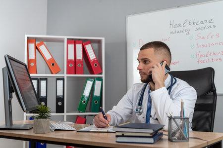 Young doctor or e general practitioner physician work in patient files at office medical clinic. Prescribing disease treatmentの写真素材