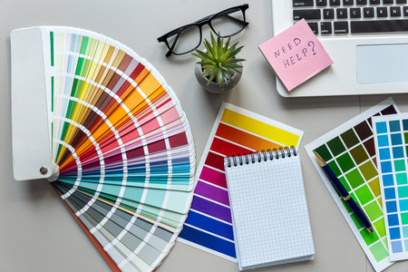 Work space of designer with color pallet, laptop, glasses notepad and pen. Creative graphic designer workspaceの写真素材