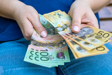 woman holding Australian Dollar money before shopping, saving concept. New aud bills aの写真素材