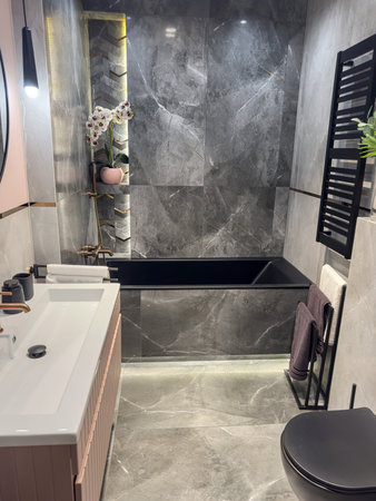 modern bathroom with bathtub and sleek tiles, accessories, sweet homeの写真素材