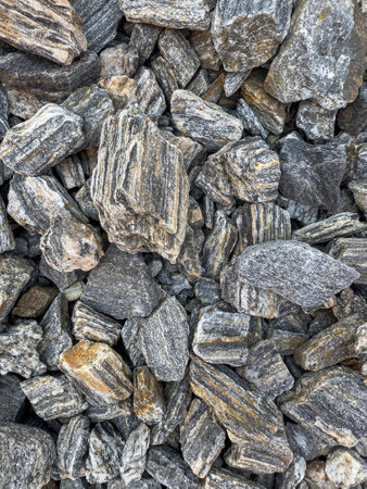 Grey natural smooth pebbles as texture or background, pebbles in garden bedの写真素材