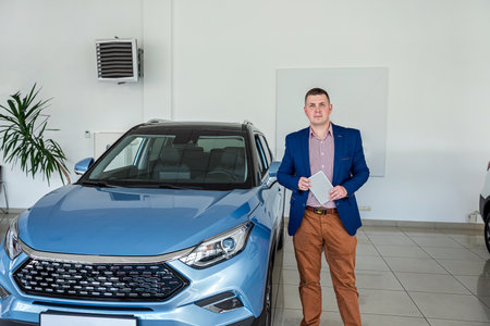 Man customer buyer in suit choosing best new car at dealership. sale or rent auto conceptの写真素材
