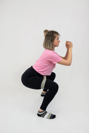 fit girl training body with resistance band isolated on white. Sport healthy lifestyleの写真素材