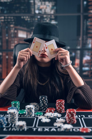 Female poker player hold two ace cards as winning game. Big luck, gambling conceptの写真素材