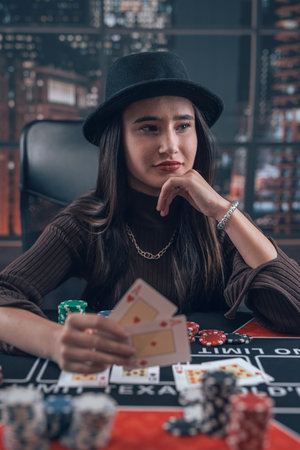 professional female player holding ace playing cards as win combination in poker game. Bet and money winningの写真素材