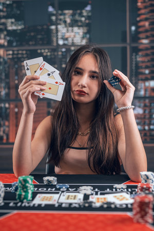professional female player holding ace playing cards as win combination in poker game. Bet and money winningの写真素材