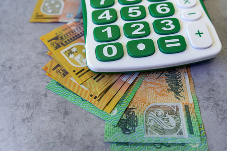 calculator with aus 50 100 australian banknotes saving money conceptの写真素材