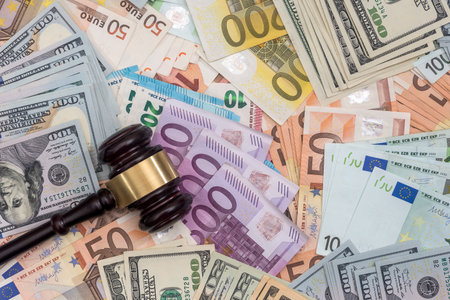 Judge gavel on dollars and euro banknotes aの写真素材