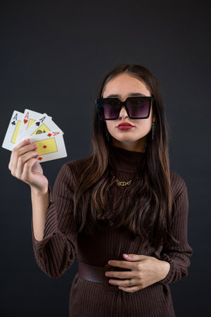 woman holding four aces in her hand isolated on black. Poker or other card gameの写真素材