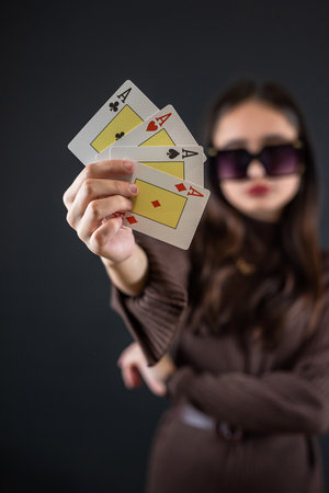 Beautiful poker player holding four aces isolated on black. Gambling conceptの写真素材