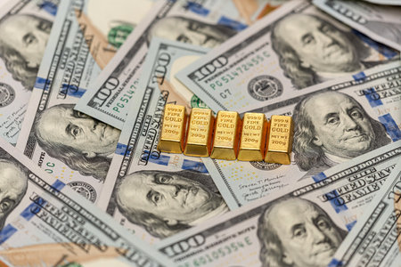 Group of gold bar on US dollar banknotes background, financial saving conceptの写真素材
