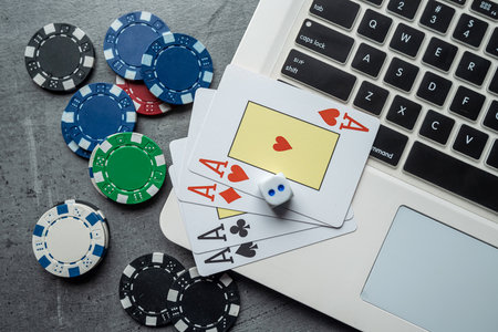 Online game concept poker playing cards and chips with laptop. Gamblingの写真素材
