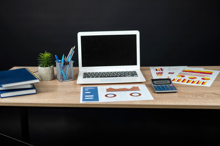 business data note book, laptop mouse graph paper document calculator for successful analyst. Workplace without peopleの写真素材