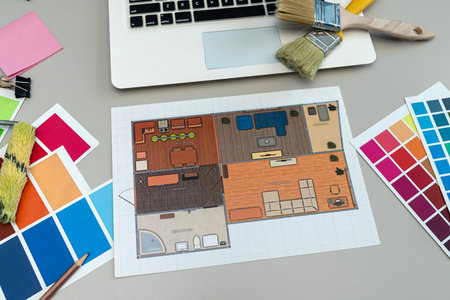laptop with paper color palette and house blueprint project on office desk. Creative workplace