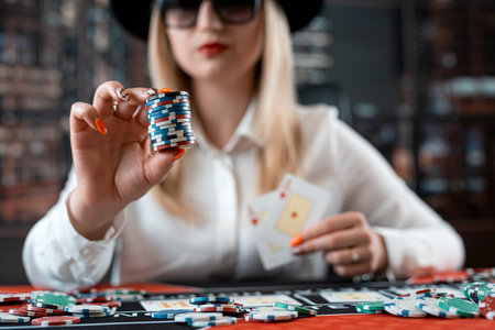 Pretty young women posing at playing table in casino. Gambling concept, Chips and cardの写真素材