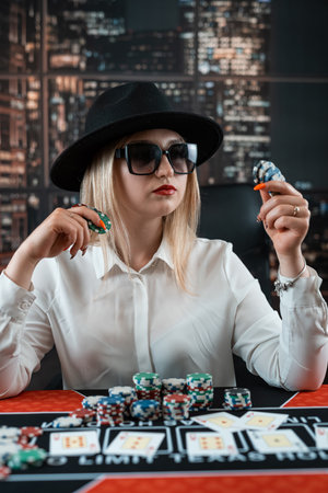 woman playing in casino and make a bet with chips all inの写真素材